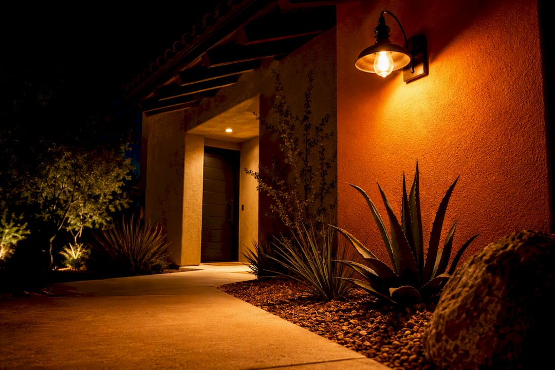 Amber porch light illuminating Arizona home entry